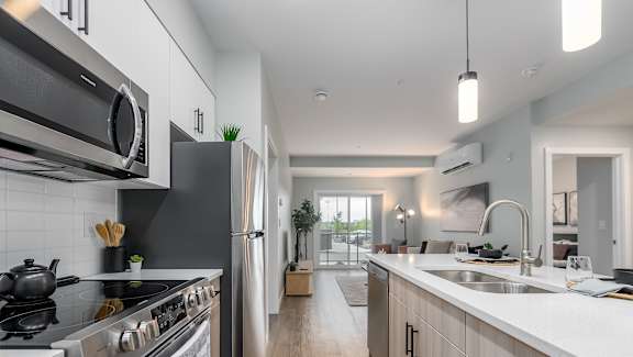 A modern kitchen with stainless steel appliances and wooden cabinets.