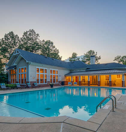 A large house with a pool in the backyard.