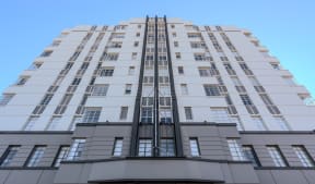 a view of a tall building with a blue sky in the background