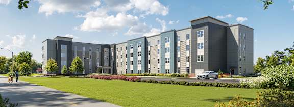 A modern apartment building with a car parked in front. at Heritage Landing Apartments, Indiana, 47803
