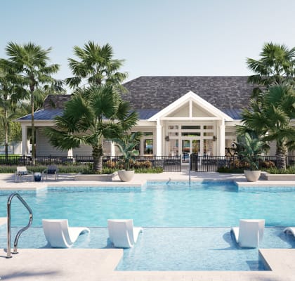 a resort style pool with lounge chairs and palm trees in front of a building