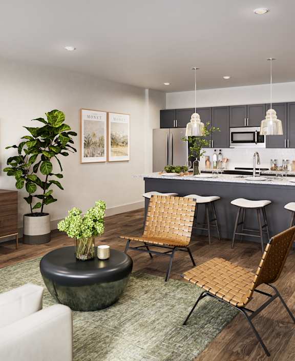 A modern living room with a white sofa, a wooden coffee table, and a kitchen area in the background. at Allier Foley in Foley, AL