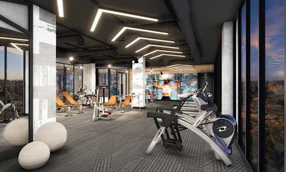 a gym with treadmills and other exercise equipment at the ceiling of a building