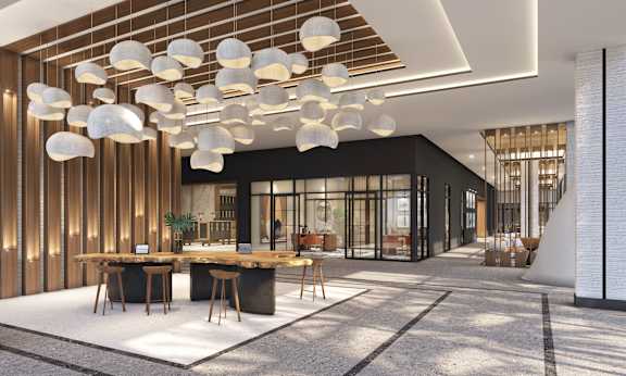A modern dining area with a long table and chairs.