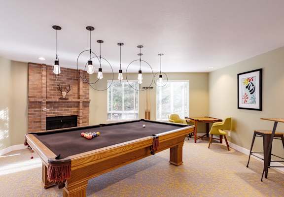 Springfield Apartments with clubhouse, pool table, fireplace and seating in Renton, WA.