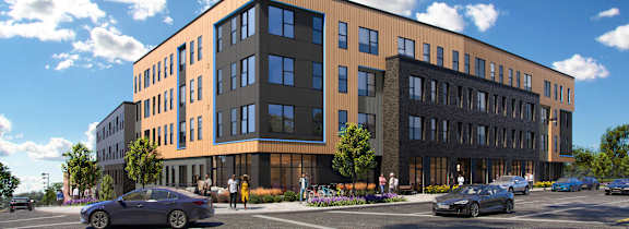 A modern building with a parking lot in front.