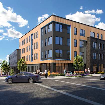 A modern building with a parking lot in front.
