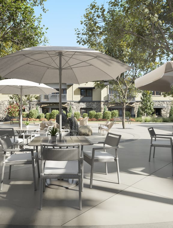 a patio with tables and chairs and umbrellas