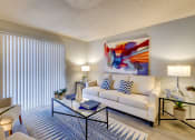 Thumbnail 2 of 15 - a living room with a white couch and a coffee table at Summers Point Apartments, Glendale