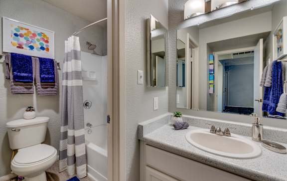 a bathroom with a sink and a toilet and a shower at Summers Point Apartments, Glendale, AZ