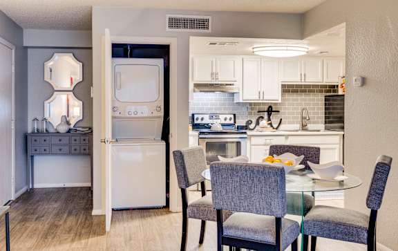 a kitchen and dining room with a table and chairs at Summers Point Apartments, Glendale