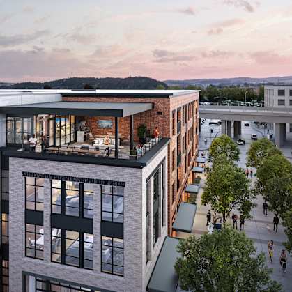 A modern building with a balcony overlooking a street.