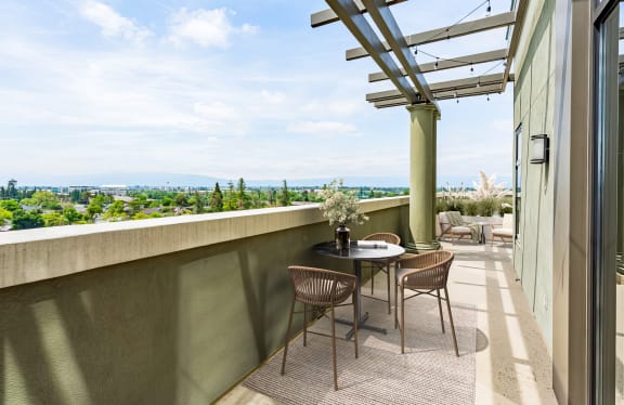 A patio with a table and chairs overlooking a scenic view at Vendome Place, California 95110