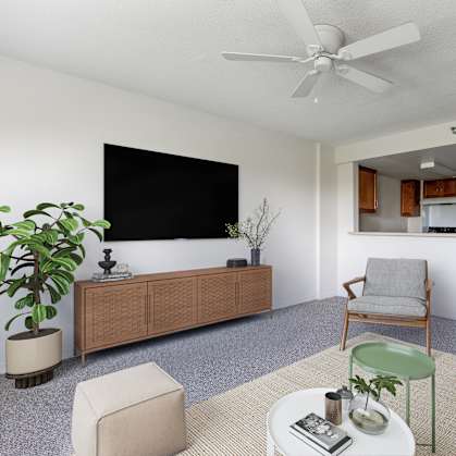 A living room with a white ceiling fan and a flat screen TV mounted on the wall.