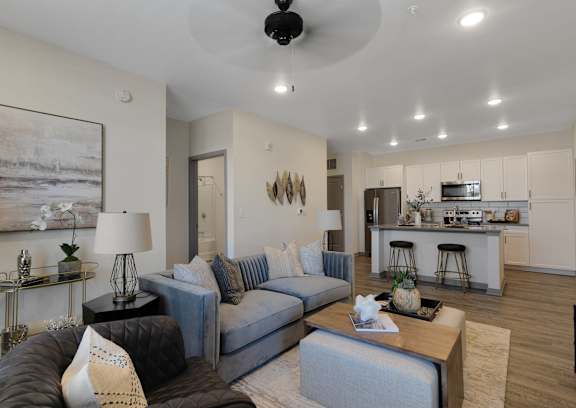 A living room with a grey couch and a coffee table.