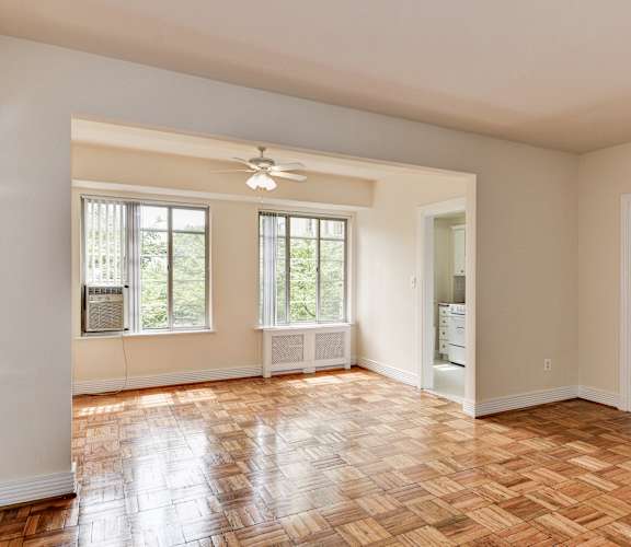 A room with a wooden floor and a ceiling fan.