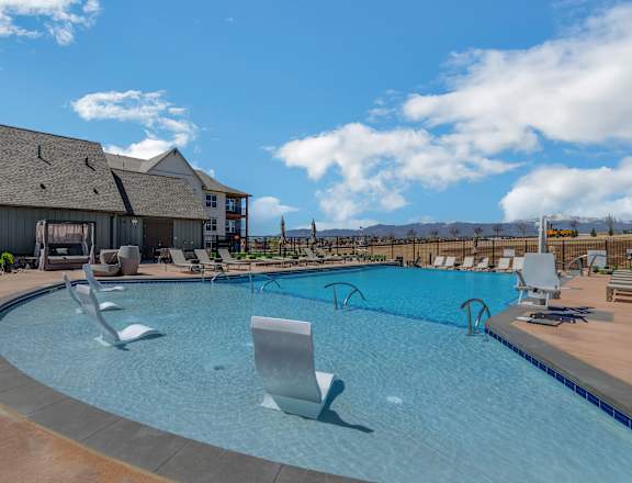A large outdoor swimming pool with a slide.
