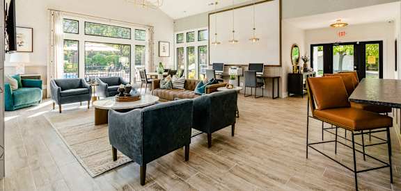 a large living room with couches and chairs and a table