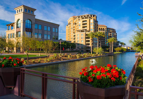 a bridge over a river with buildings in the background
