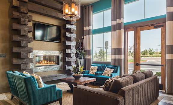 a living room with couches and chairs and a fireplace at Estate at Woodmen Ridge, Colorado Springs, 80923