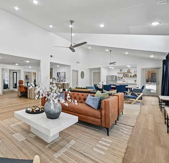 A modern living room with a large sofa, chairs, and a coffee table.