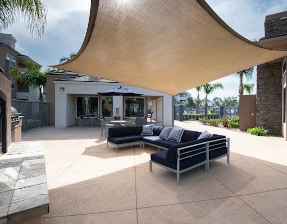 A modern outdoor seating area with a curved wooden roof.