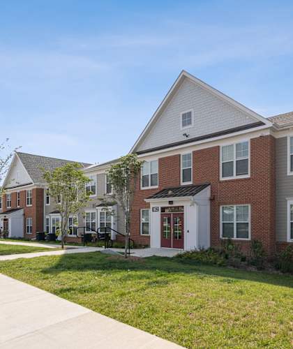 a row of brick homes with a sidewalk in front of them