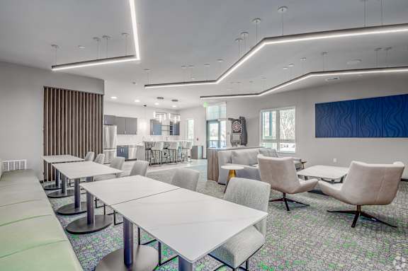 A conference room with a long table and chairs.