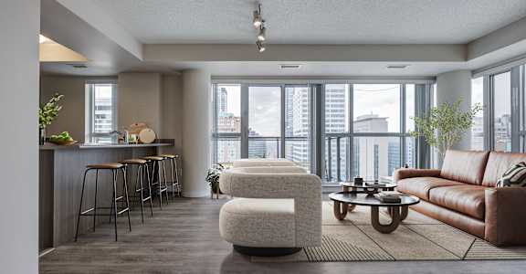 A modern living room with a bar area and a view of the city.