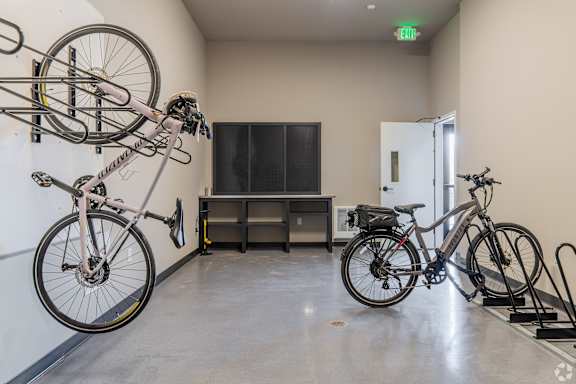 A bike is hanging on a wall in a room.