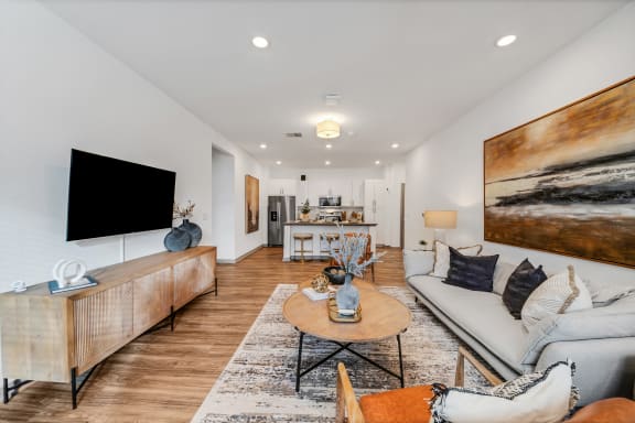 a living room with a couch and a tv at The BLVD at Wilson Crossings, Wyoming, MI 49418