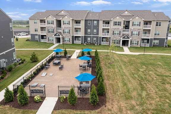 A large apartment complex with a courtyard and seating area.