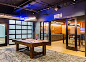 Thumbnail 2 of 5 - a game room with a pool table and a bar