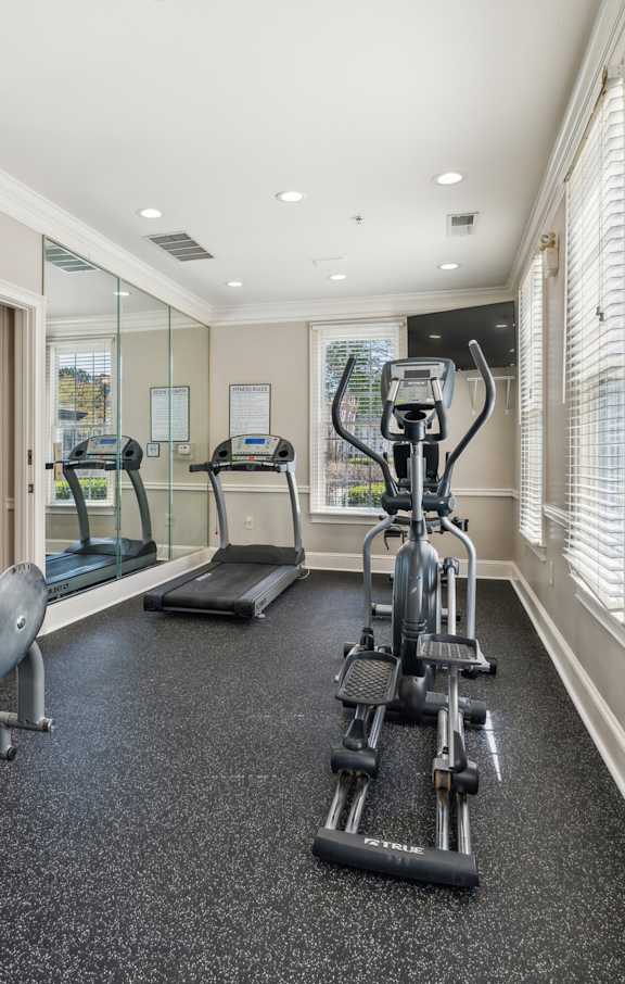 A home gym with a treadmill, elliptical trainer, and stationary bike.at The Atlantic Canton Ridge, Canton, GA 30114