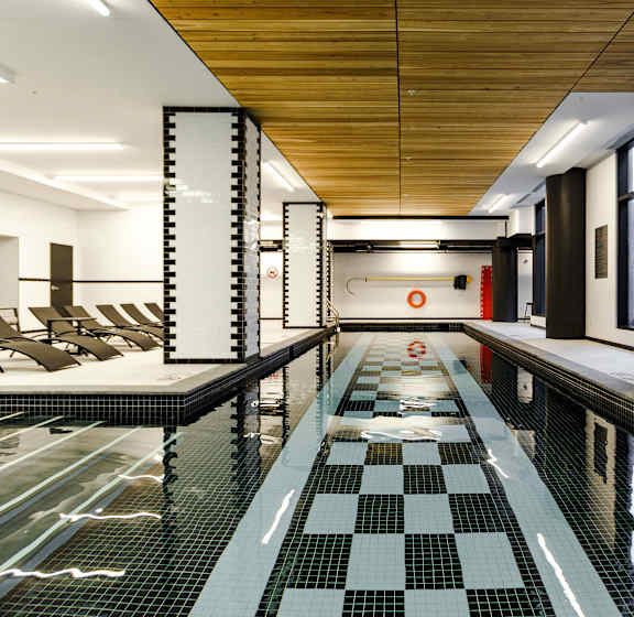 a large swimming pool with chairs in a lobby