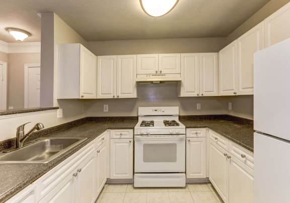 A kitchen with a countertop and a plate with blue napkins on it.