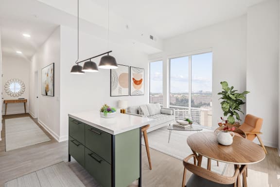 an open floor plan with a kitchen island and a living room with a large window