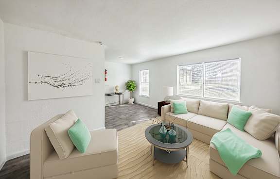 A living room with a grey chair and a wooden table.
