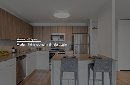 A modern kitchen with a dining table and chairs.