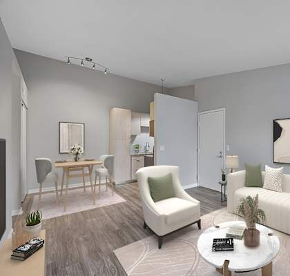 A living room with a white sofa, a white armchair, a coffee table, and a painting on the wall.