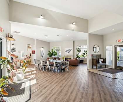 a living room and dining room with a table and chairs