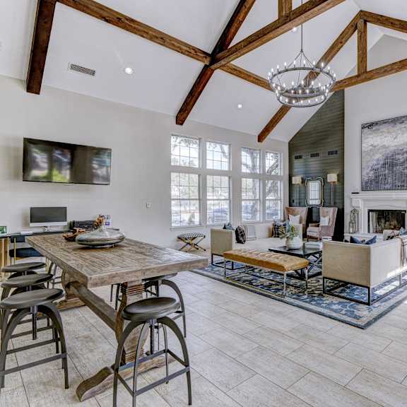 A kitchen with a stone floor and a dining table.at Villages of Briar Forest, Houston Texas
