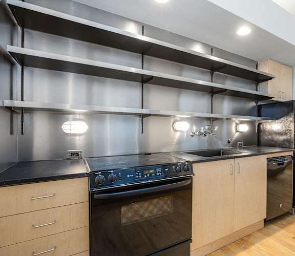 a kitchen with stainless steel appliances and wooden cabinets