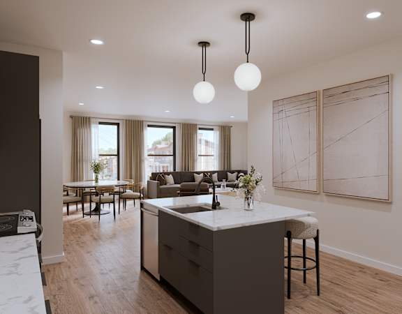 A modern kitchen with a large island and pendant lights.