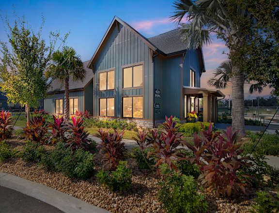 a home with a landscaped garden in front of it at Canter Ocala, FL 34474