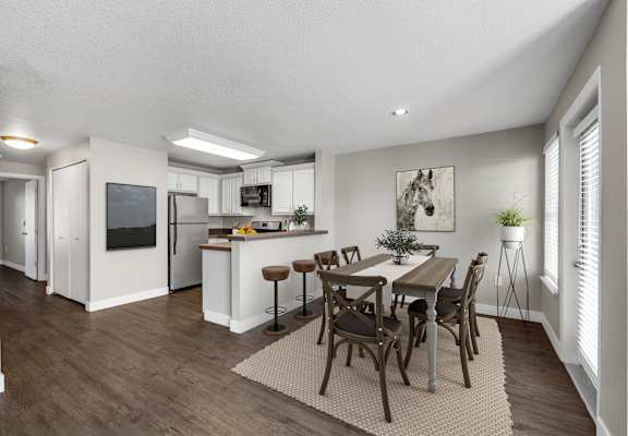 A modern kitchen with a dining table set for four.