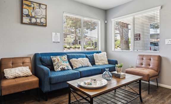a living room with a blue couch and a coffee table