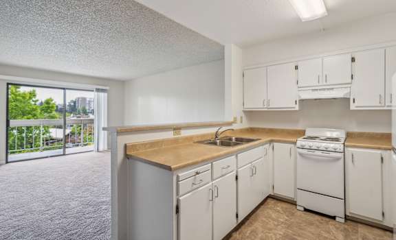the preserve at ballantyne commons apartment kitchen with white appliances and counter tops