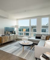 a living room with a couch and a table and a large window