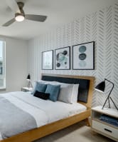 a bedroom with a large bed and a ceiling fan